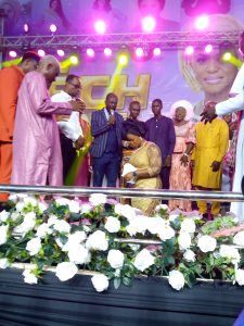 The celebrant receives prayers from Ministers of God