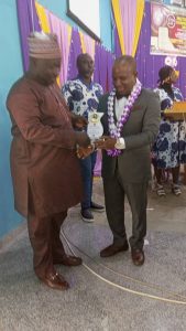 The Deputy Rector Administration, Dr. M. O. Akinola, (left) presents the award to Chief Chuks Onyemulu