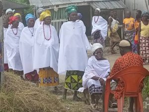 The women on white garments are called emeba (King's Maids), going to different streets of Ewu community, making sacrifices of appreciation to the gods for their protection