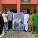 3rd R - Hon. (Pharm) Victor Ofobrukueta receiving portrait picture from the LG PDP Chairman, 2nd L - Hon. Felix Erhimedafe at council secretarial while others look on