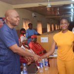 Dr. Charles Olisa (left) with one of the beneficiaries